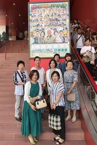 ポスターの前で記念写真