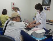 組合が実施する集団健康診断を受ける組合員（左）